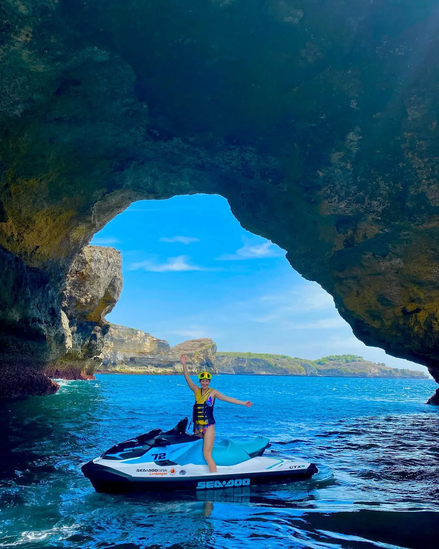 Guest on a jet ski inside a sea cave near Nusa Lembongan